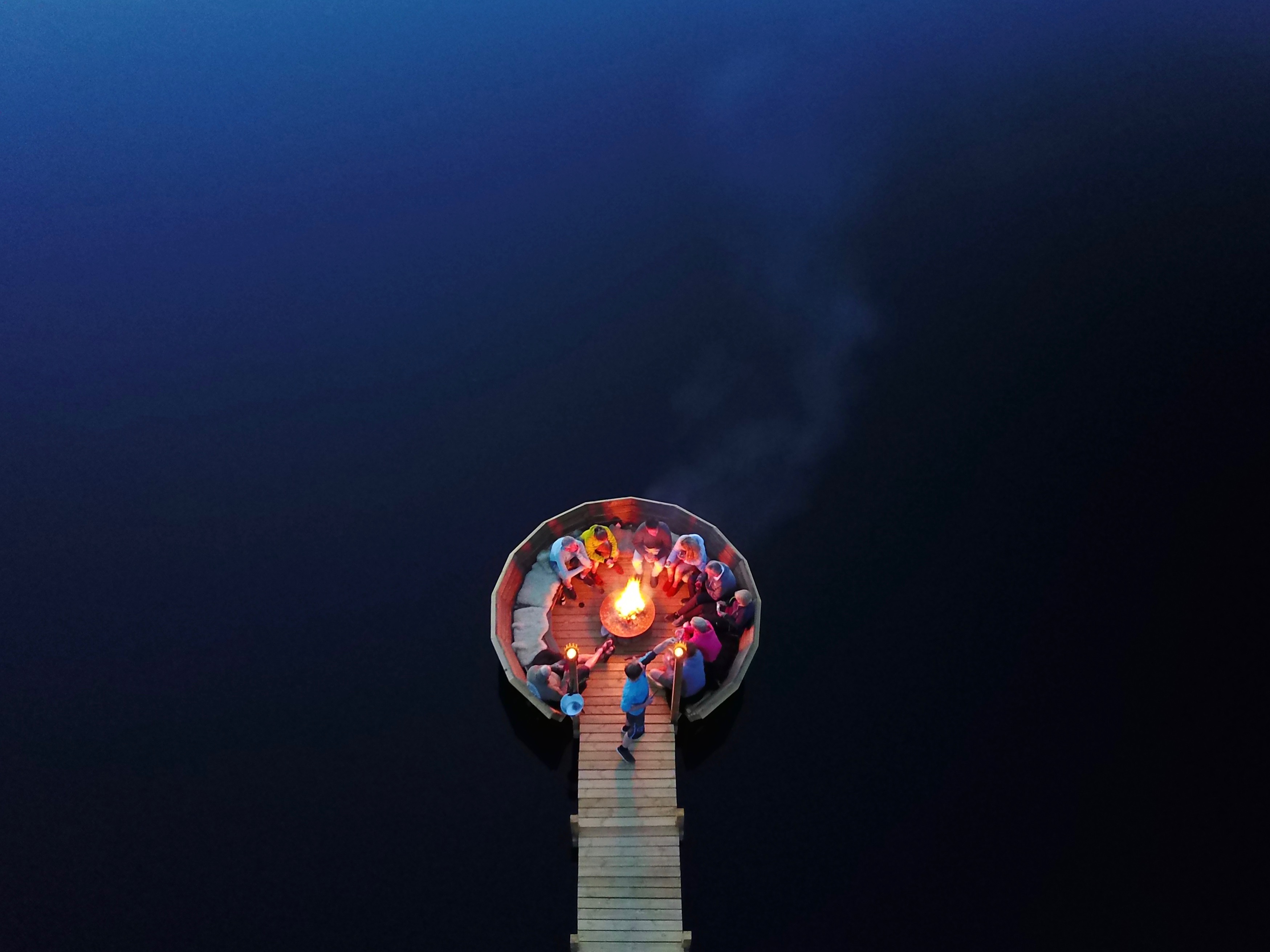 Camp fire on lake pier 