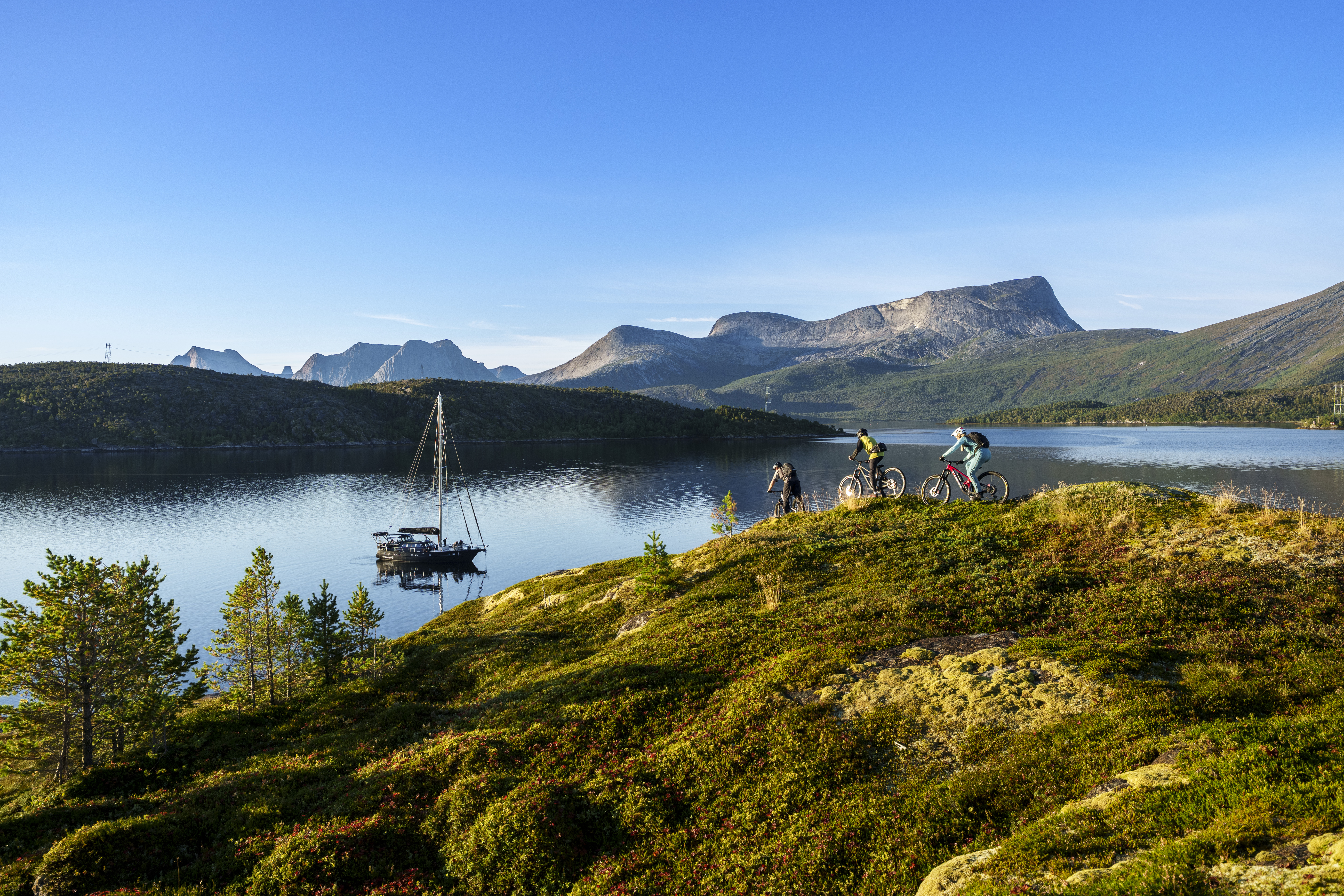 Mountain bikers riding down to sailboat