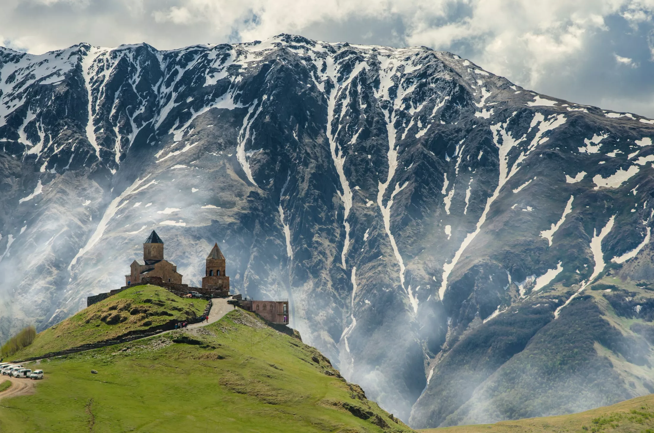 A cathedral on top of a hill in the mountains