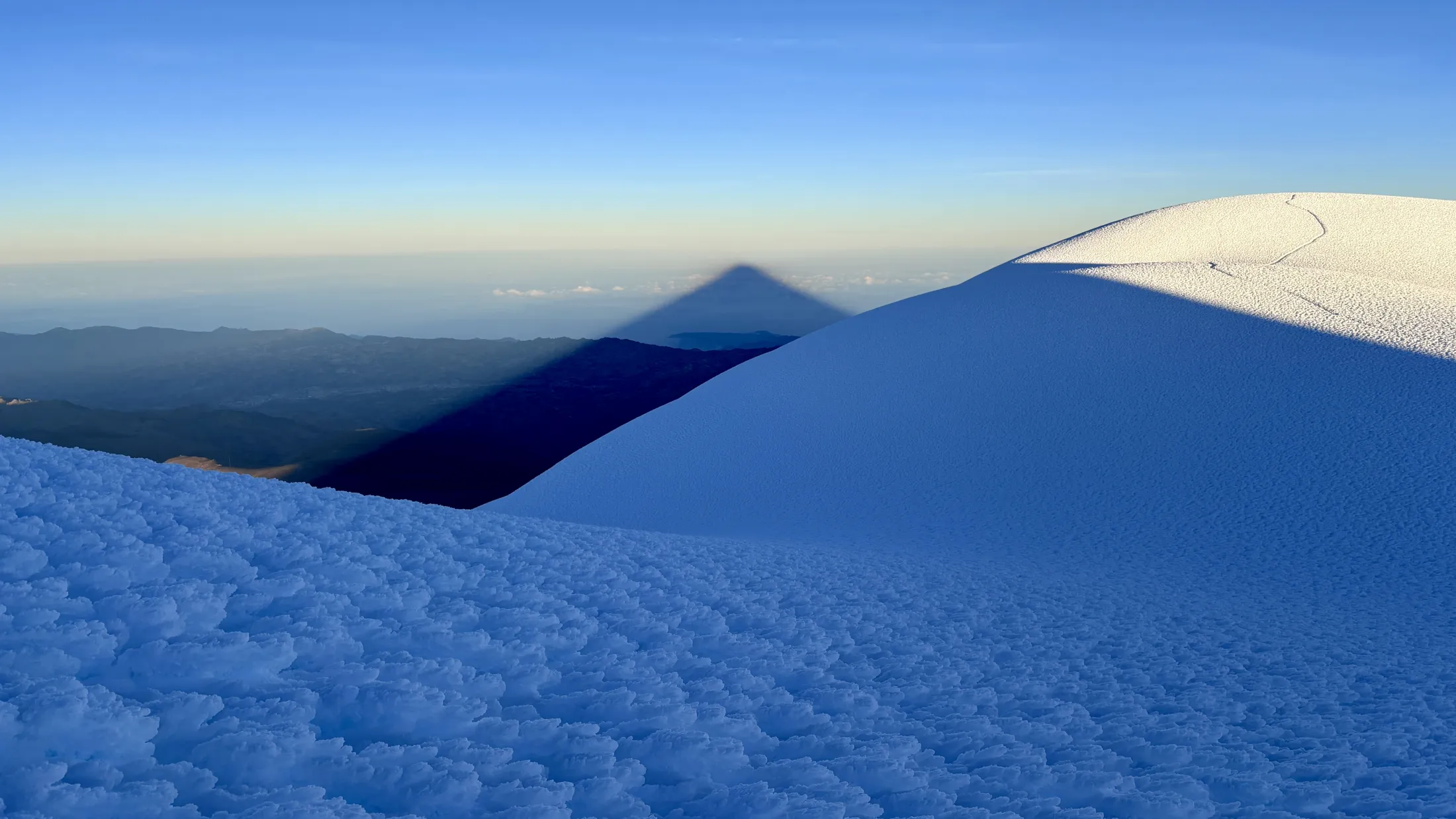 Volcano cone shadow at sunrise 
