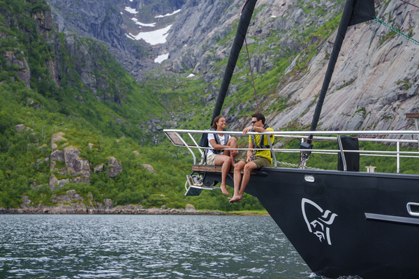 Two people sitting on the bow of a boat