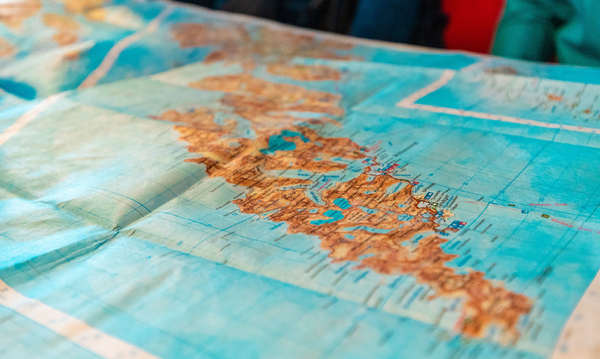 A large map of Lofoten, Norway spread out on a table.