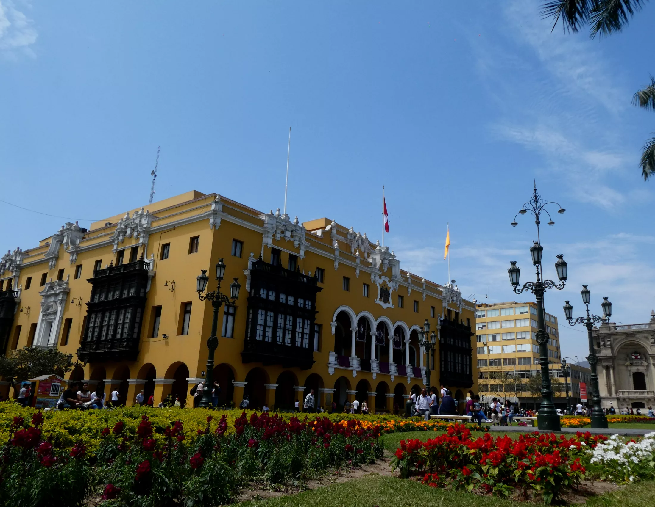 A yellow building in front of a park