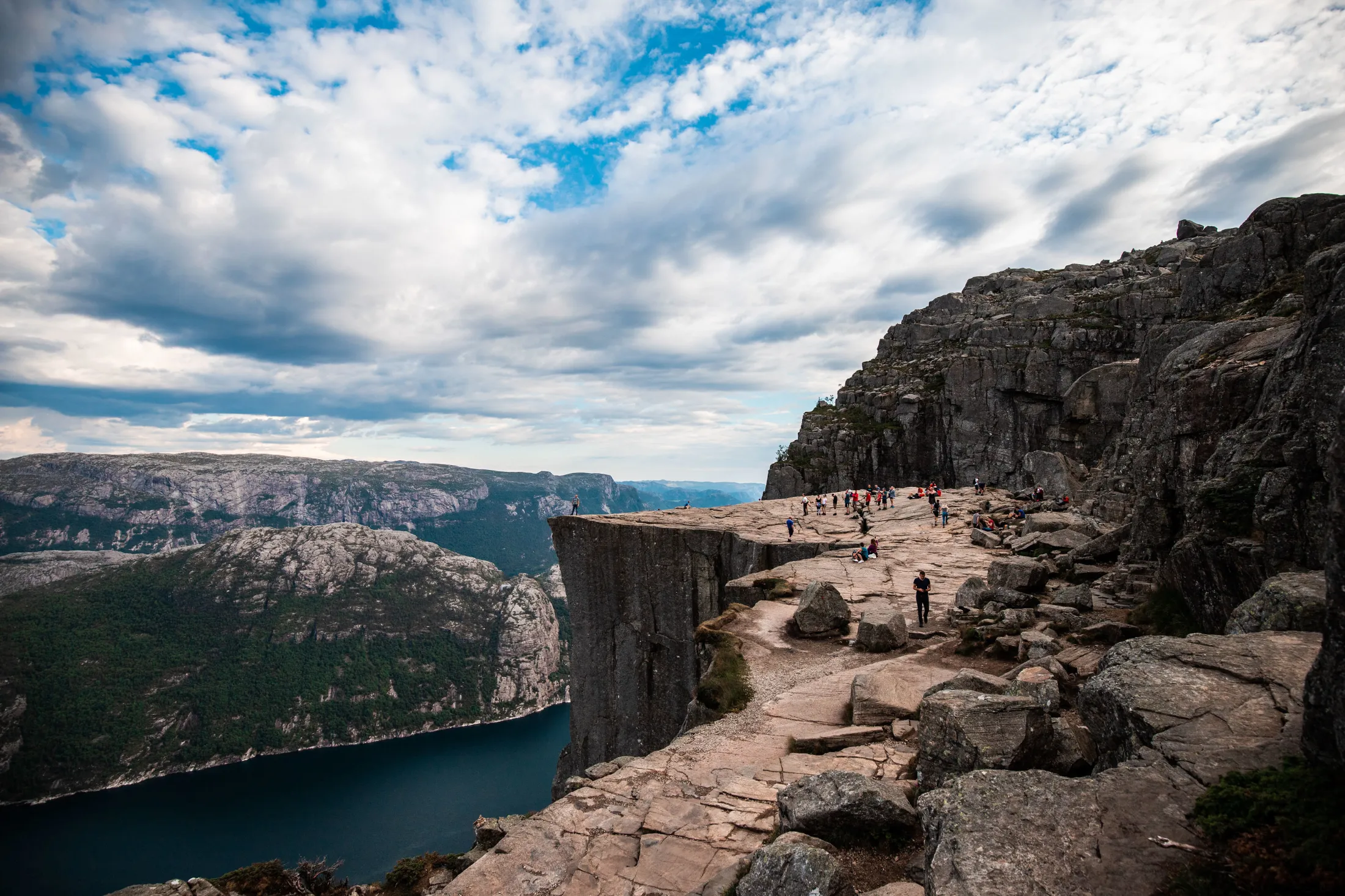 Several people on a mountain cliff.
