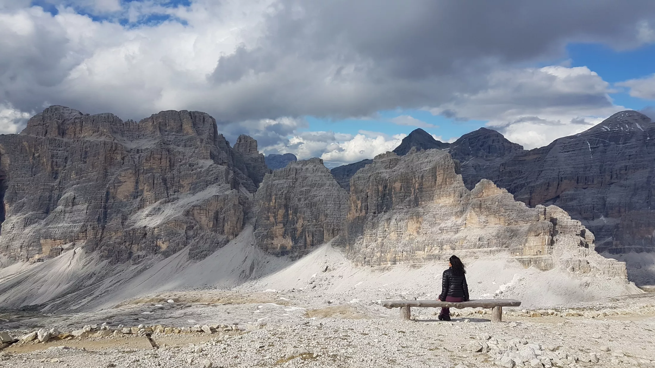 Person on bench in the mountains.