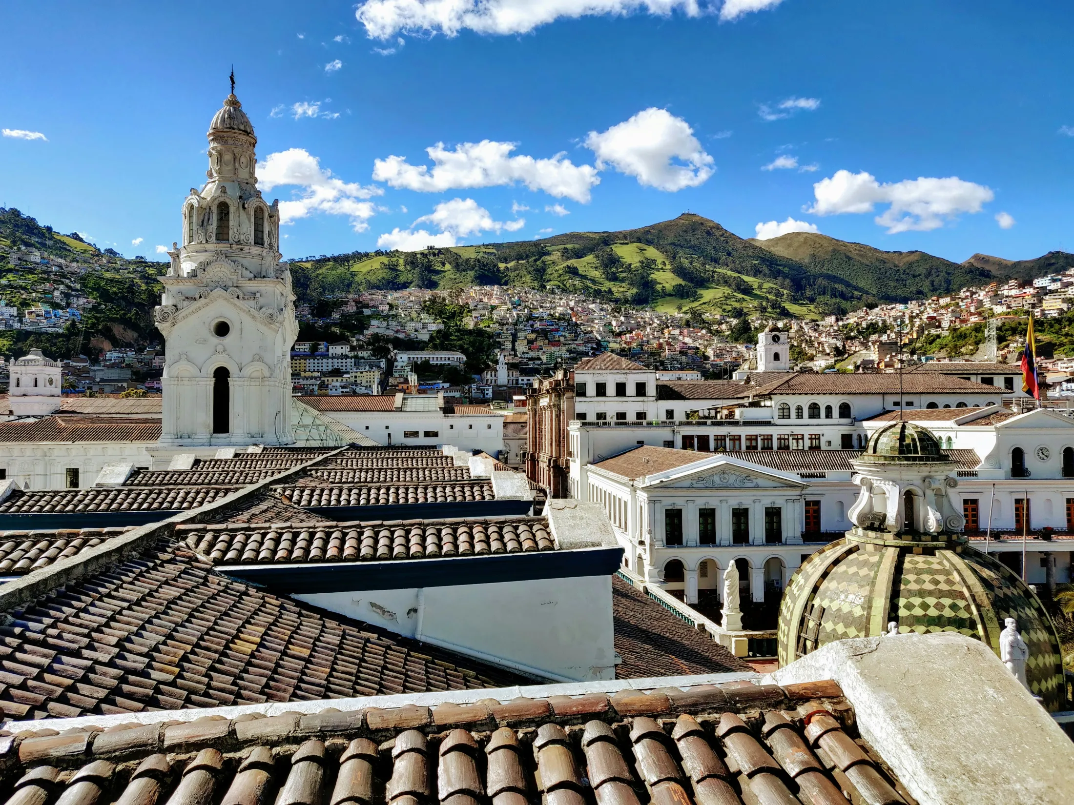 A view from a roof over a city with old Spanish architecture.