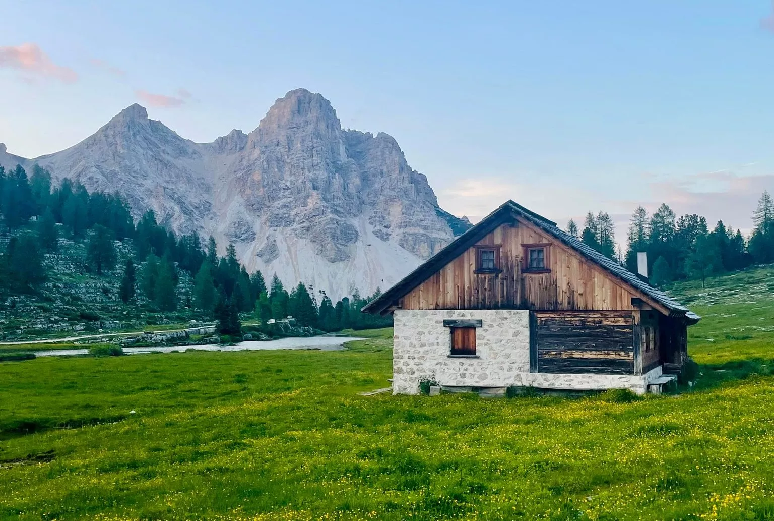 Barn on a field in mountains