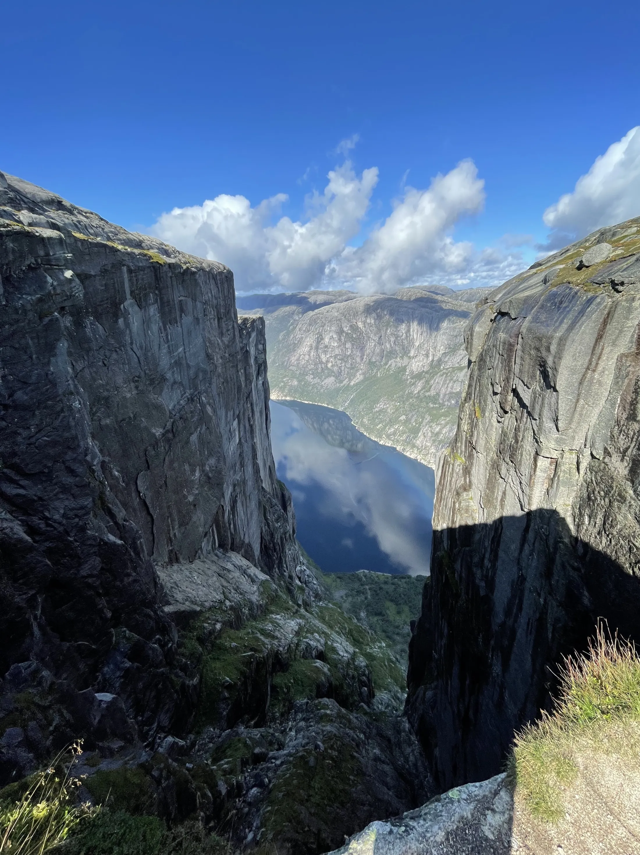 Mountains and a fjord between the mountains. Blue sky.