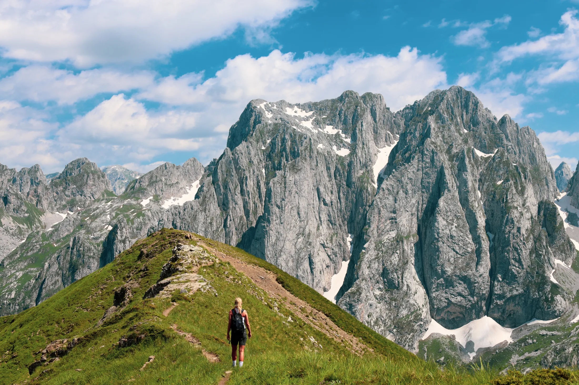 Person walking on a mountain ridge.