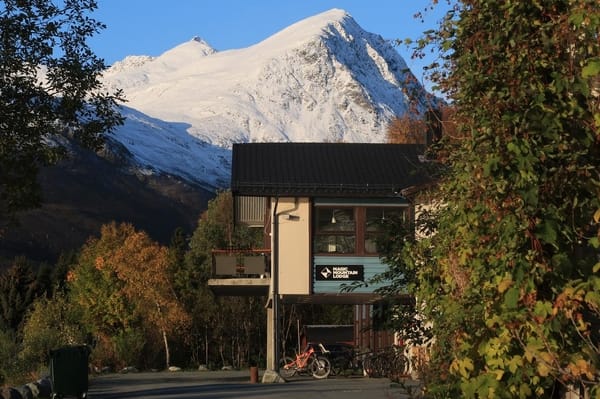 A building with a snow-covered mountain in the background.