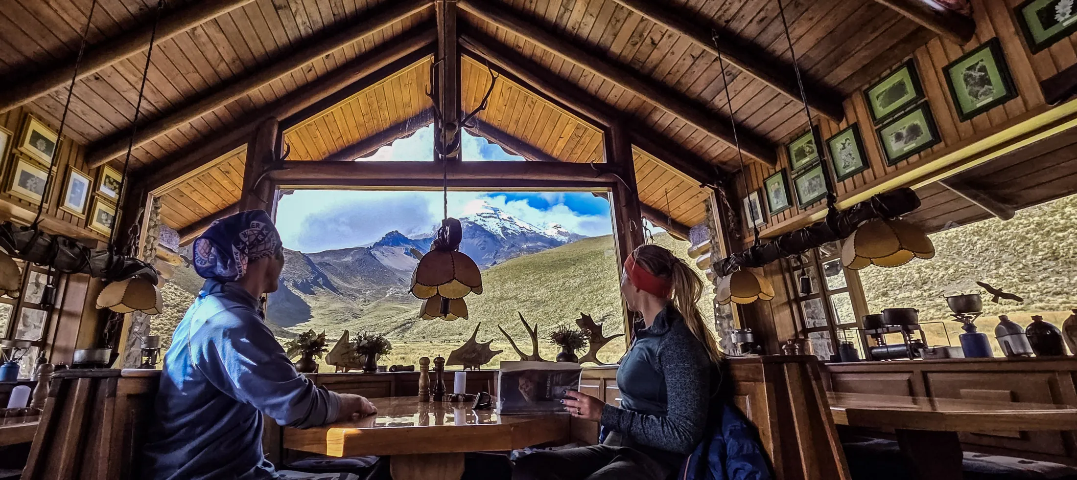 Two people sitting at a table in a mountain lodge 