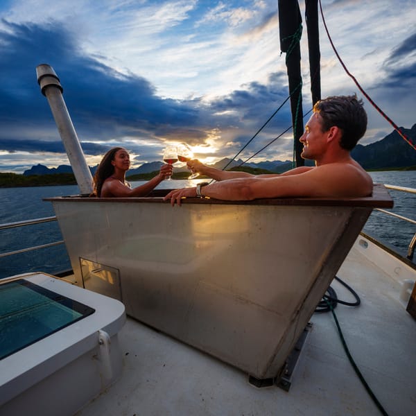 Two people in a hot tub on a boat in the ocean
