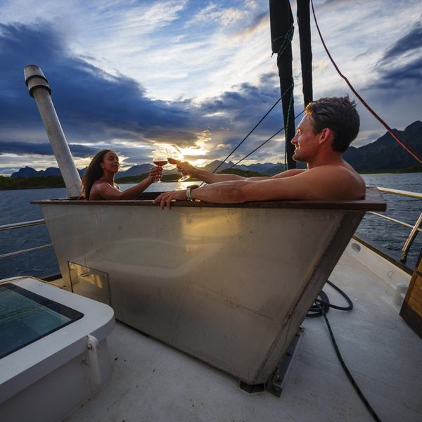 Two people in a hot tub on a boat in the ocean