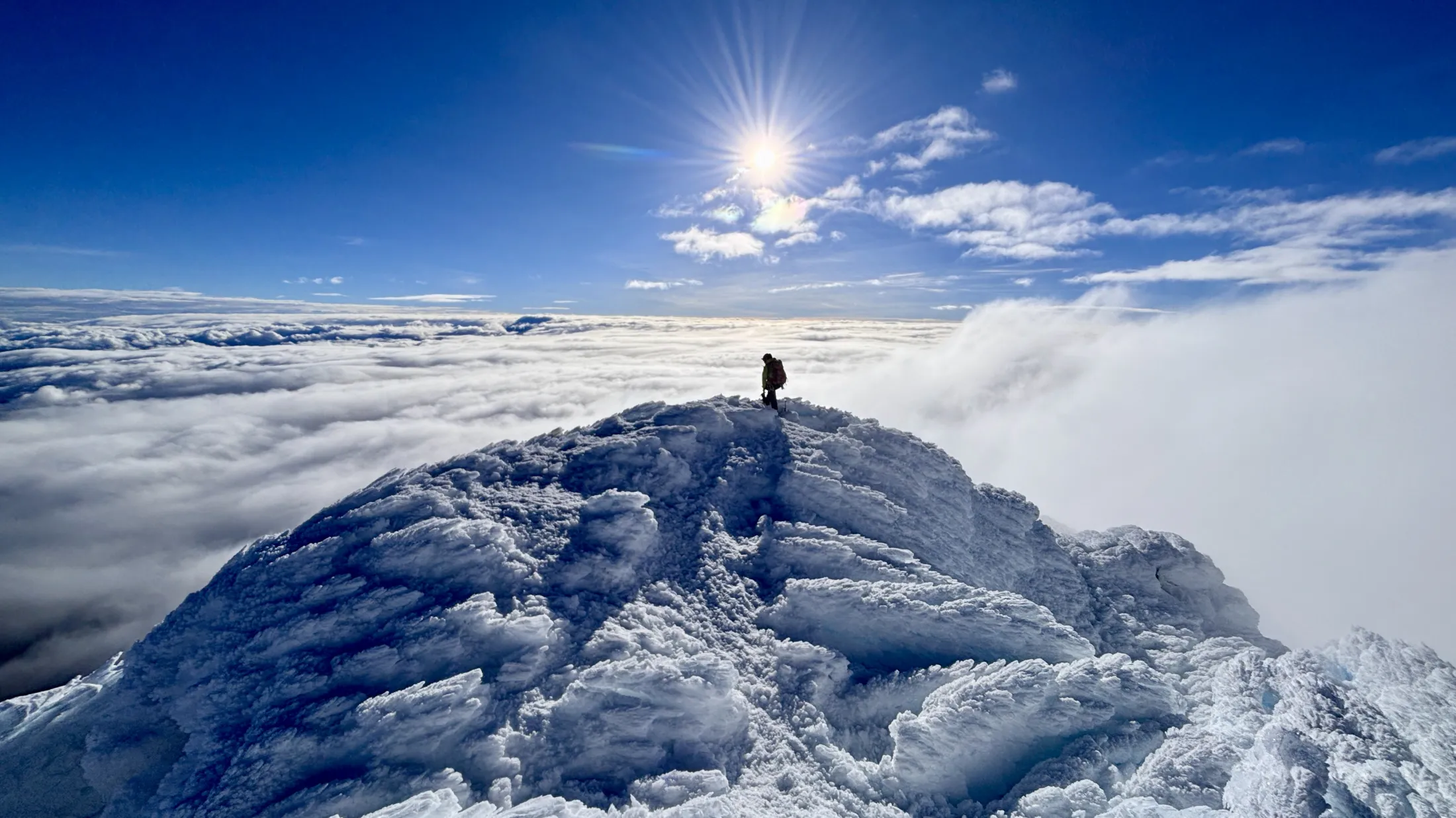 Lone hiker at top of mountain 