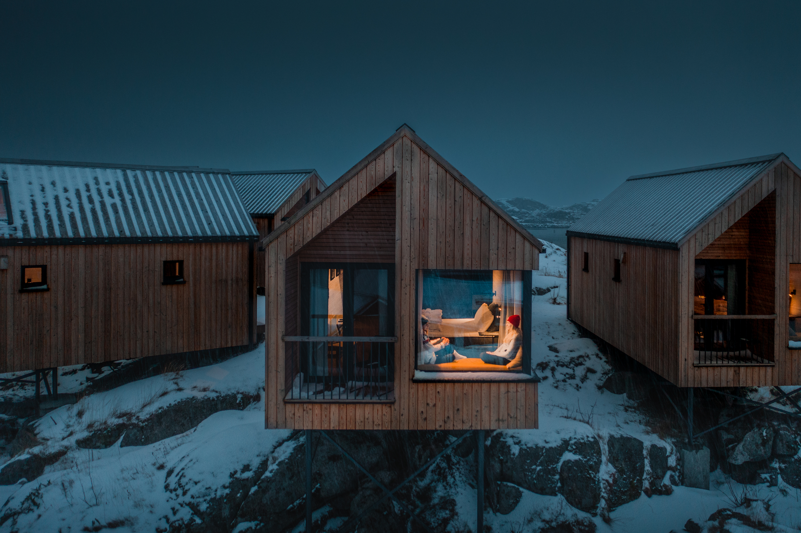 Cozy wooden cabin in the dark and snow