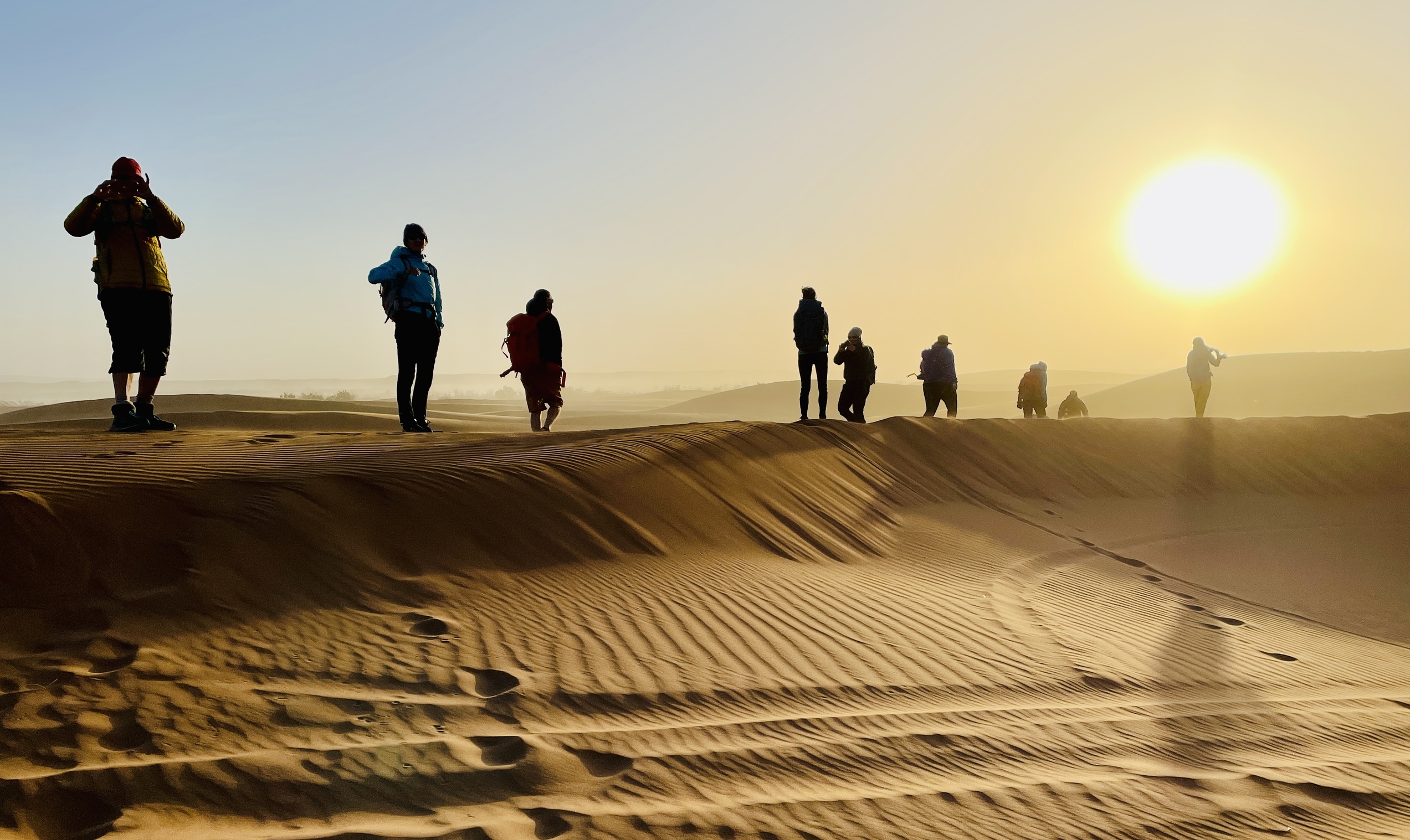 People walking in the desert in the sun