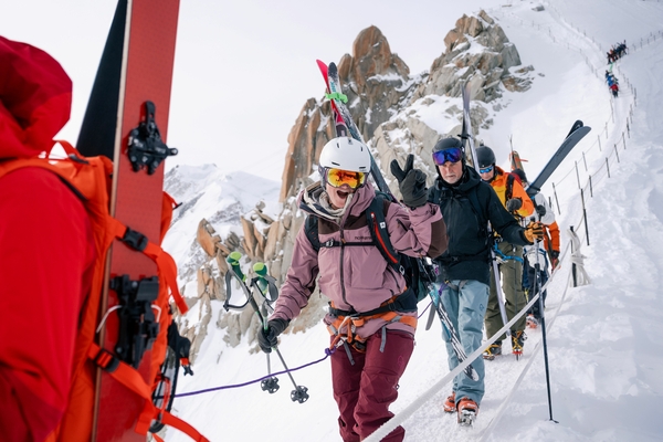 Skiers hiking down a ridge line