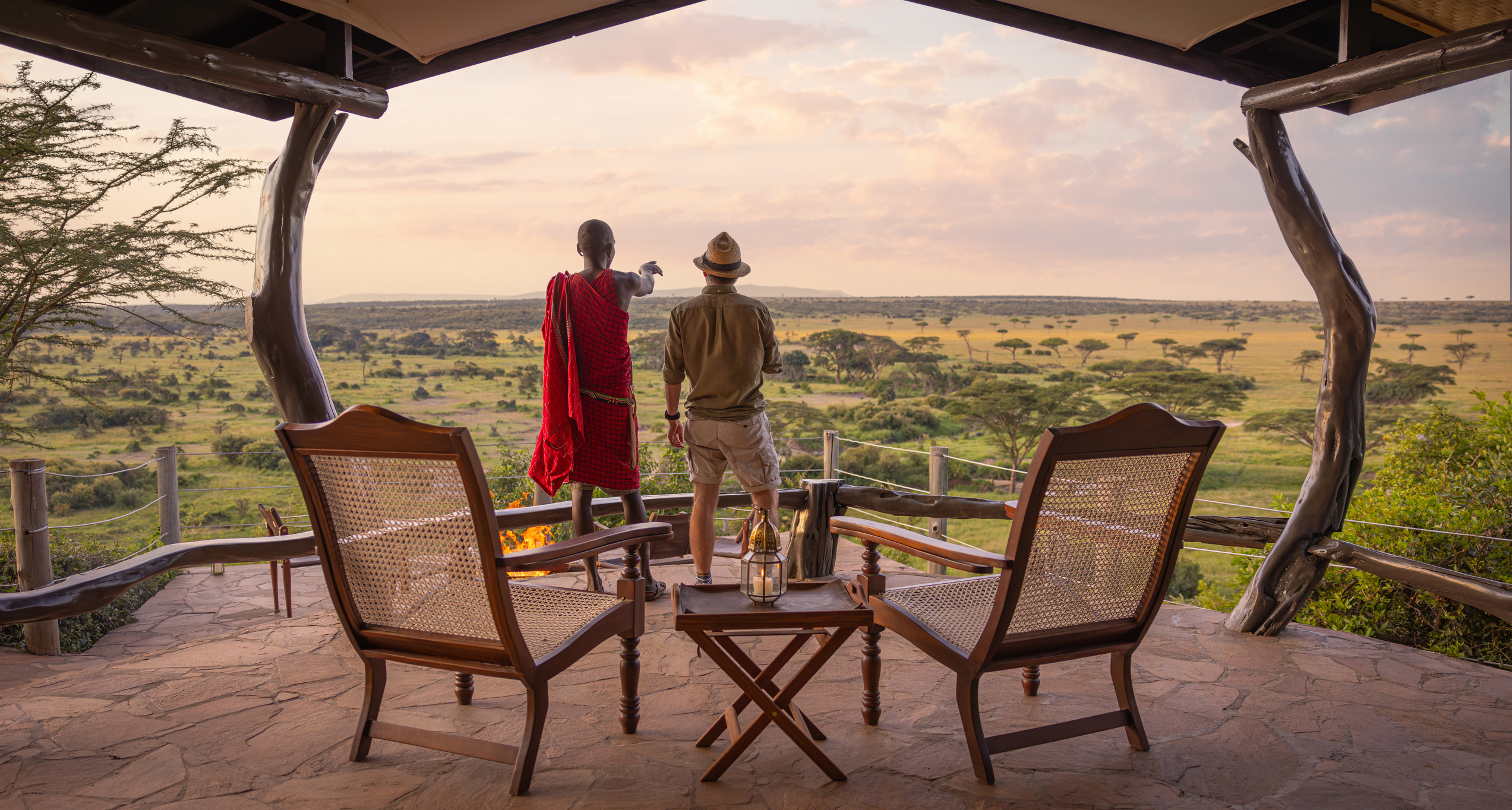 Masai and person with the savannah in the background