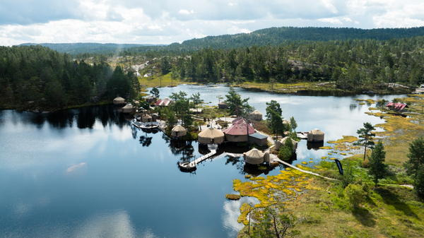 Aerial of a yurt camp in forest