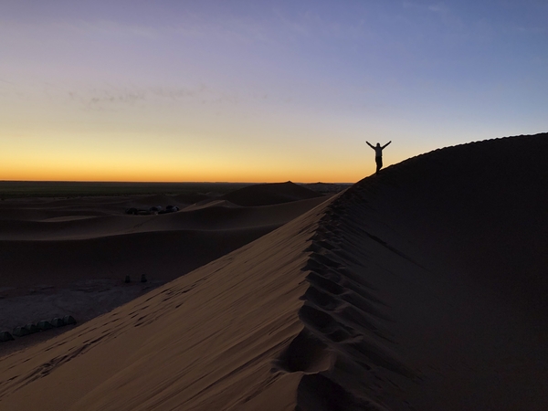 Person on a sand dune in the desert