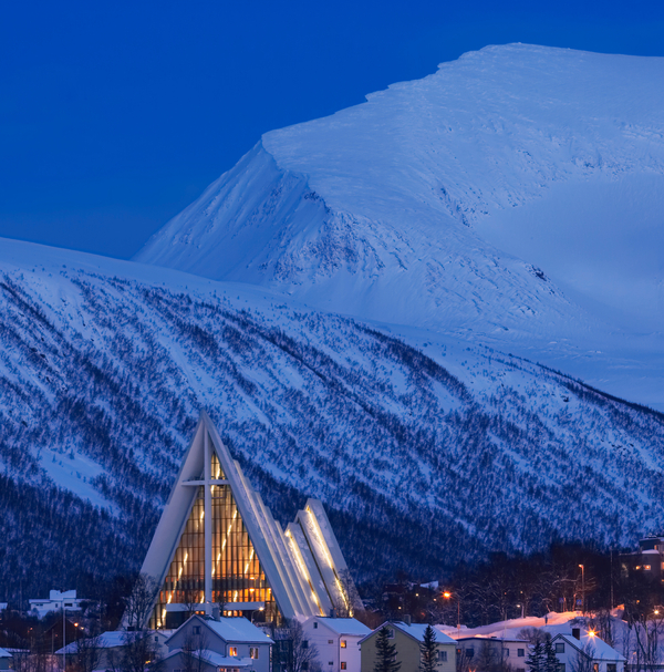 Arctic cathedral in front of mountains in the blue hour 