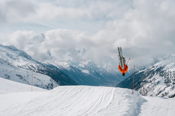 A skier doing a blackflip off a jump