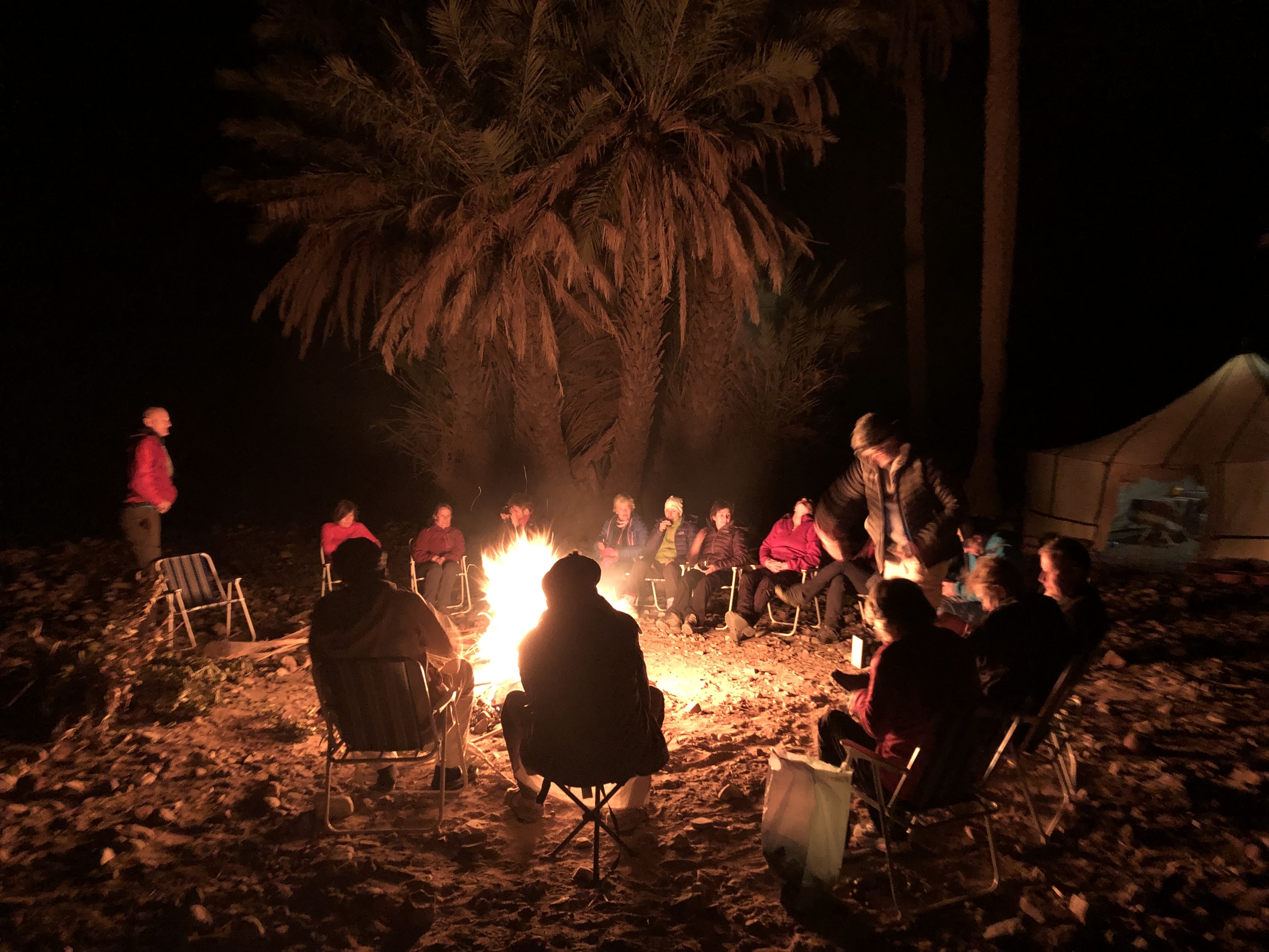 People around a bonfire in the desert