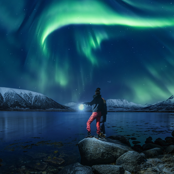Northern lights over mountains and a hot tub