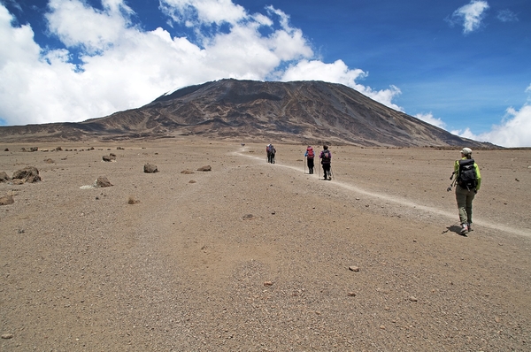 People walking on a dirt path mountains