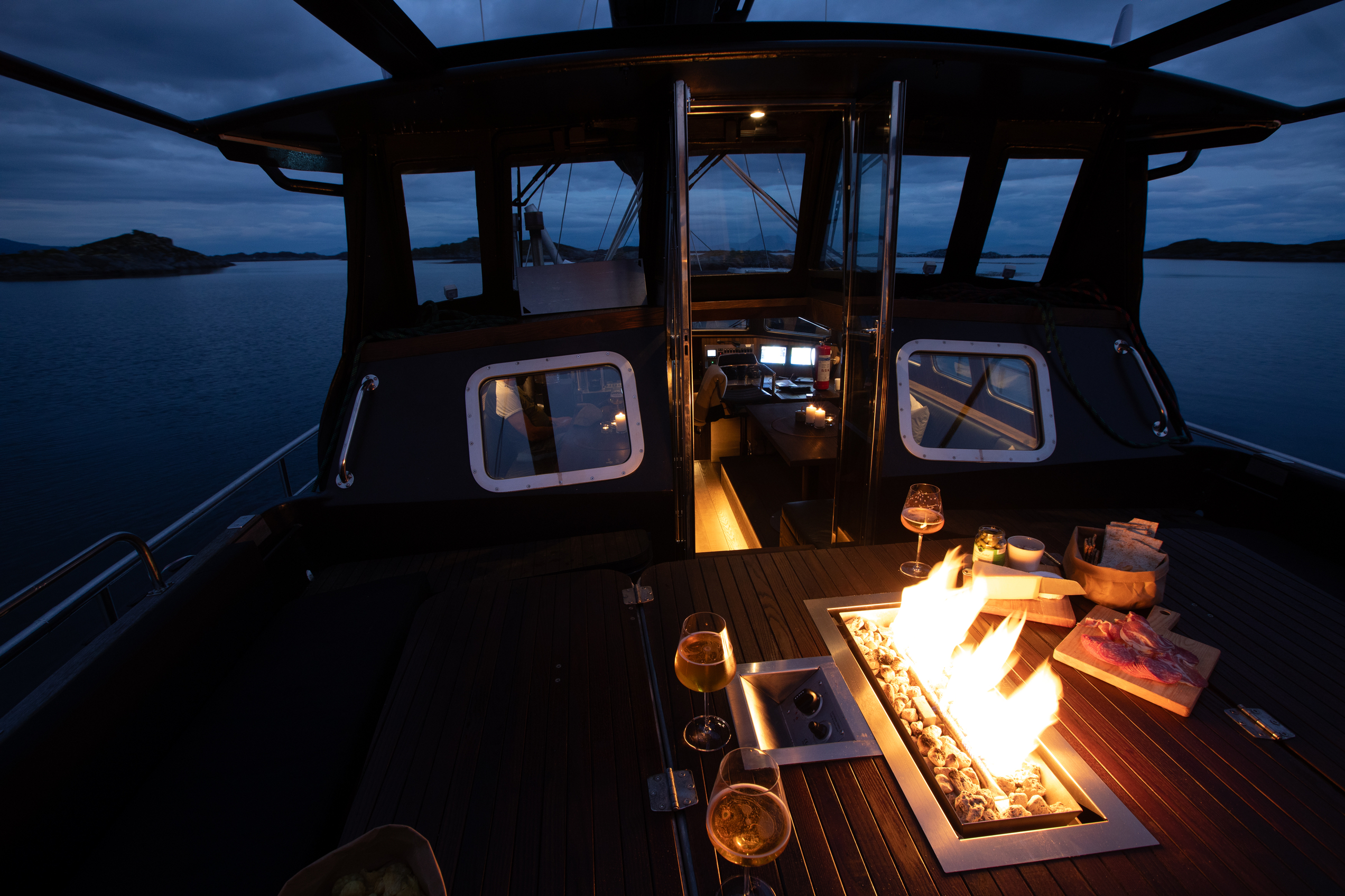 Fire pit with charcutterie and wine on a sail boat
