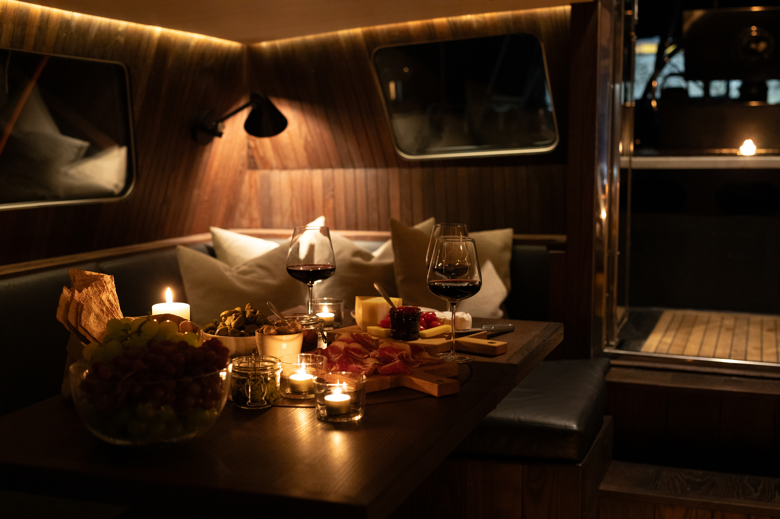 Charcutterie board with wine inside a sail boat