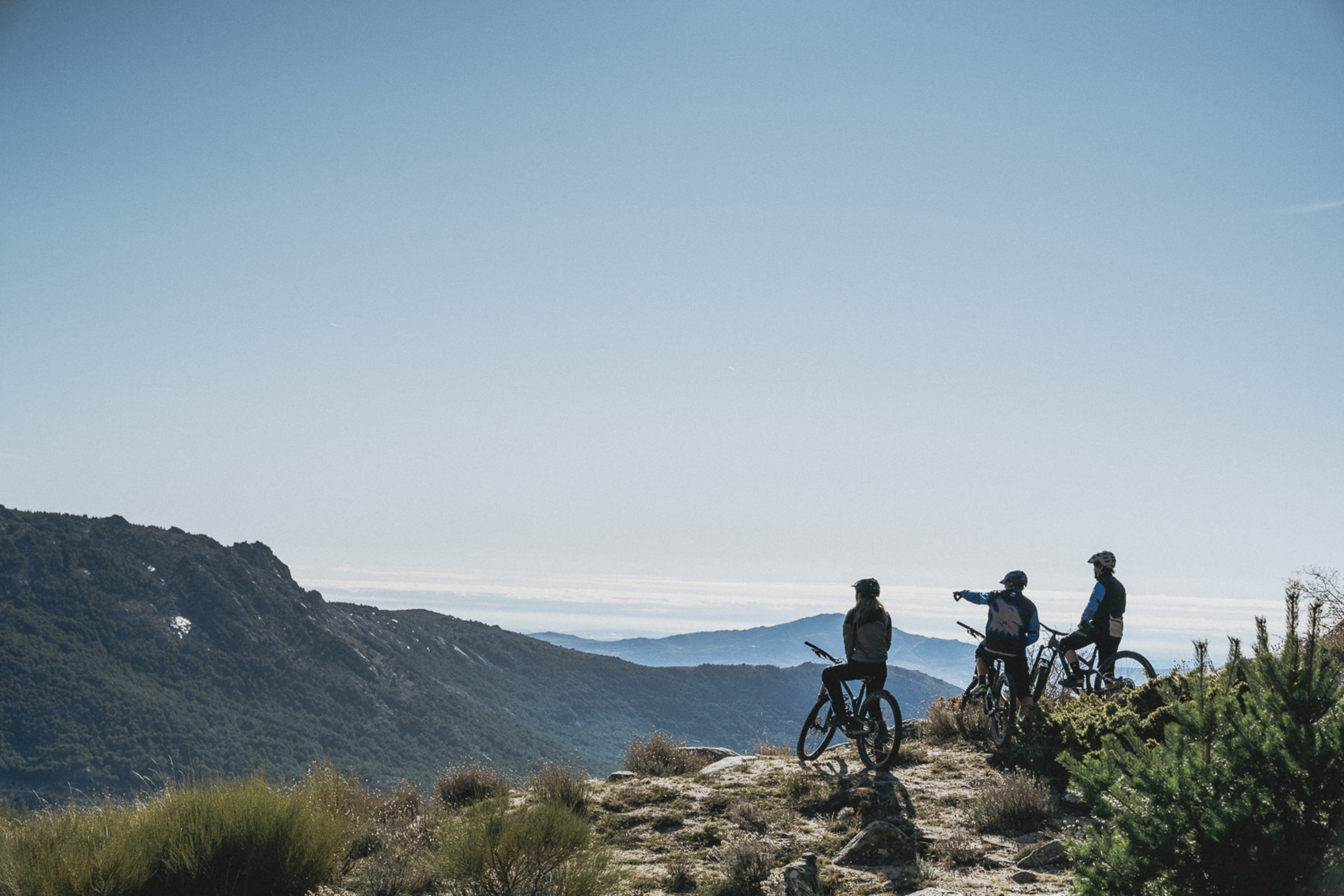 Mountain bikers pointing out to horizon