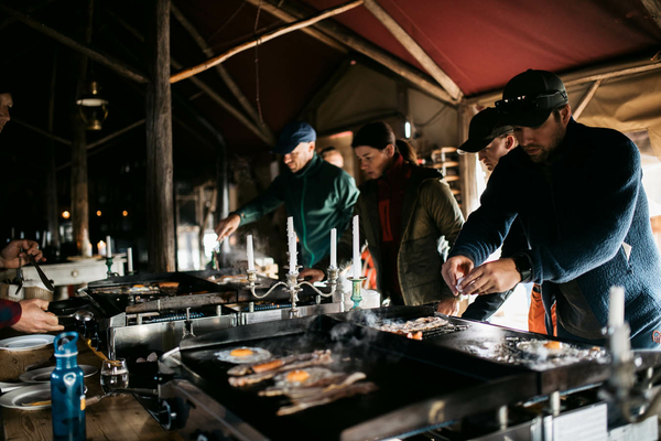 People serving breakfast in a yurt