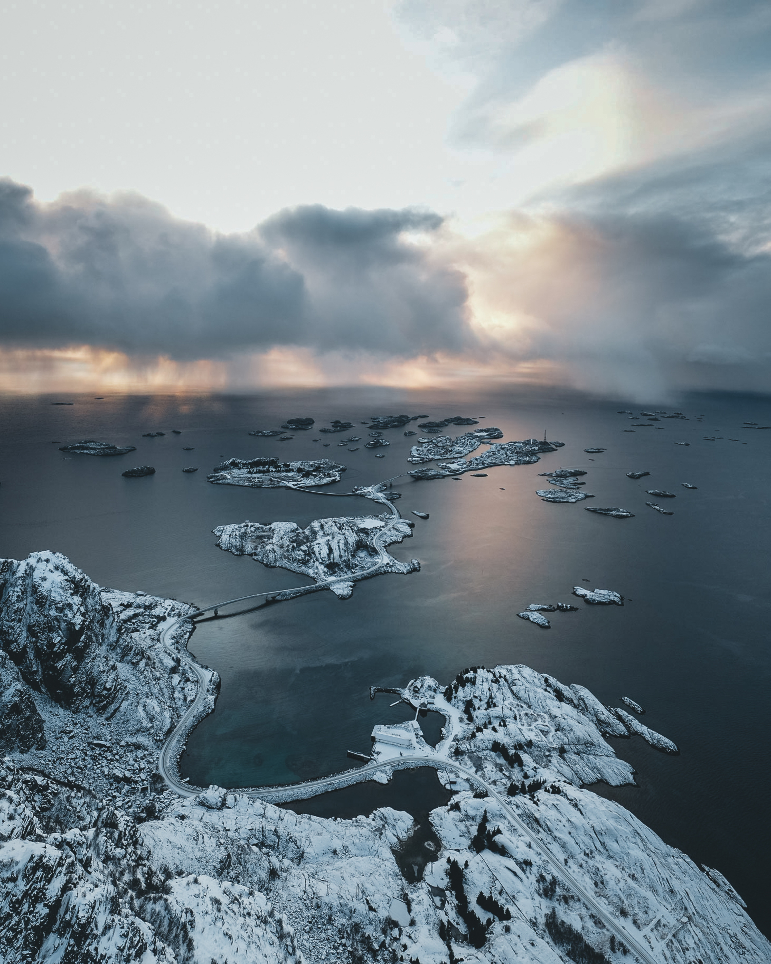 Overview of small connected islands covered in snow with clouds