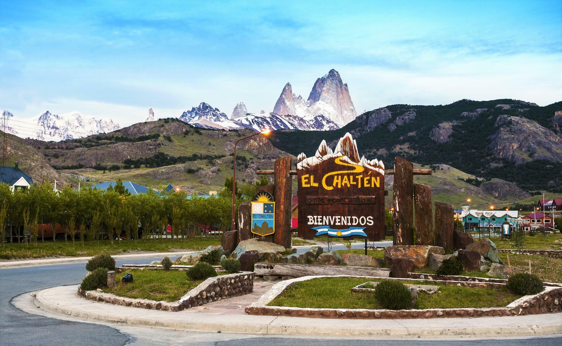 Welcome to El Chalten village sign. Fitz Roy mountain range in t