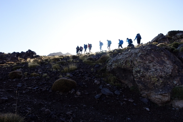 Turgåere på en åsrygg på et fjell med blå himmel